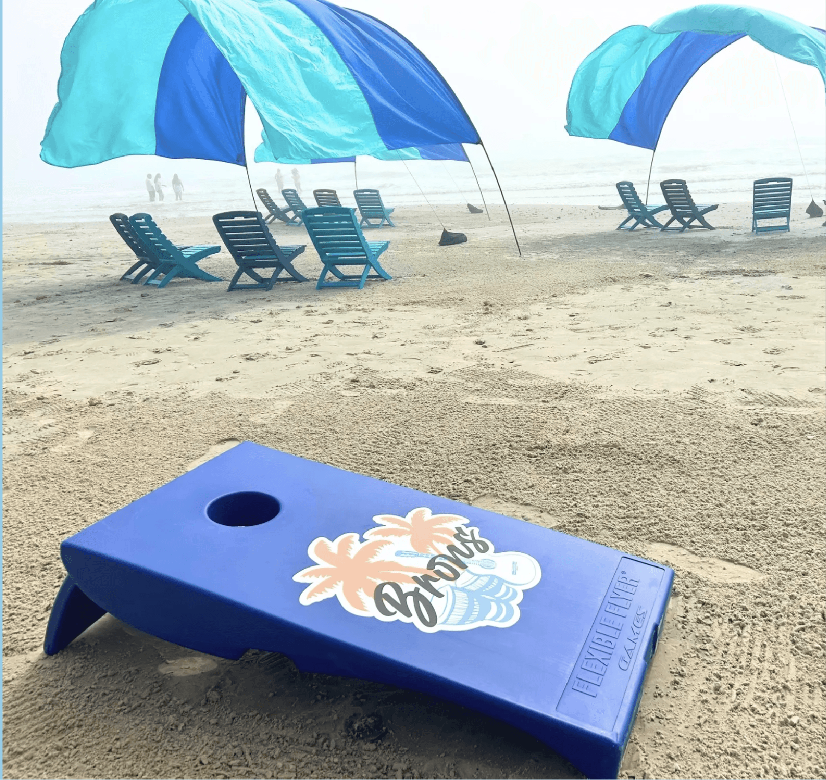 Bron's beach setup with cabanas and chairs